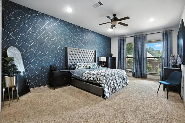 a bedroom with a bed and a chair