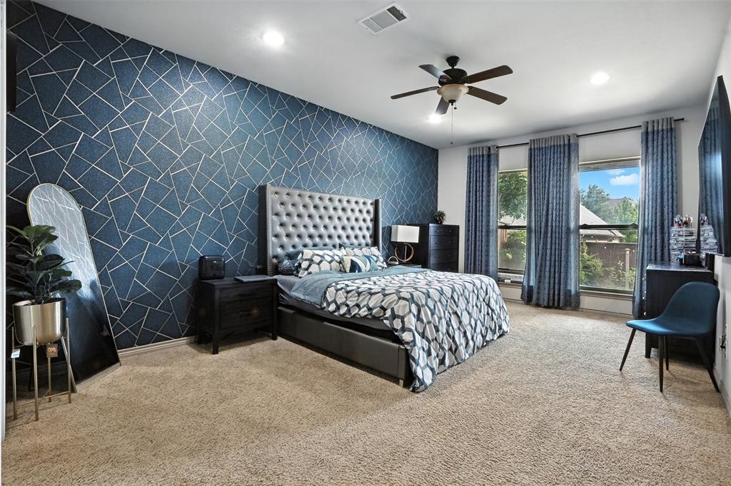 200 Thistle Ridge Denton, TX 76210 - Photo 21 of 31 a bedroom with a bed and a chair