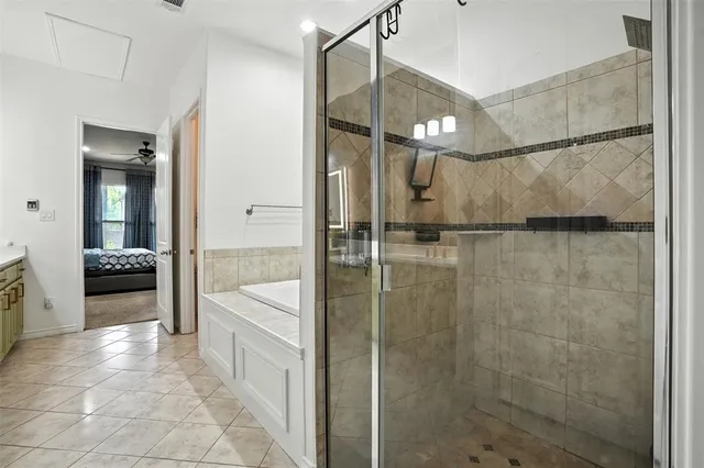 a spacious bathroom with a tub shower and sink
