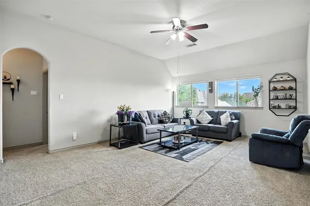 a living room with furniture and a large window