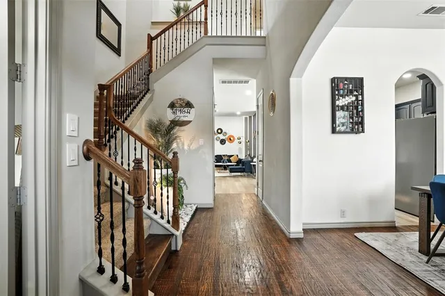 a view of a hallway with wooden floor and staircase
