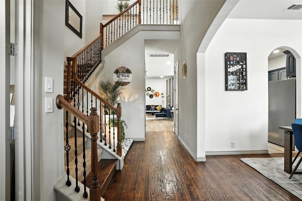 200 Thistle Ridge Denton, TX 76210 - Photo 4 of 31 a view of a hallway with wooden floor and staircase