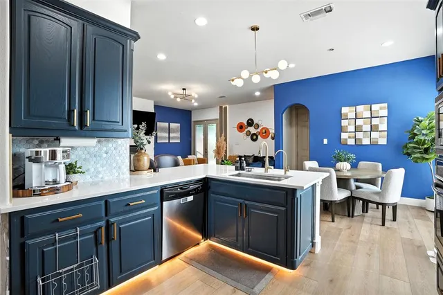 a kitchen with a sink a counter space appliances and cabinets