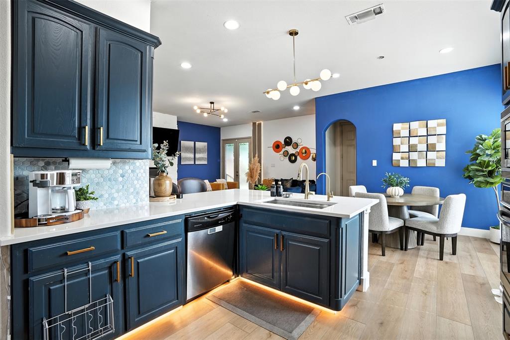 200 Thistle Ridge Denton, TX 76210 - Photo 8 of 31 a kitchen with a sink a counter space appliances and cabinets