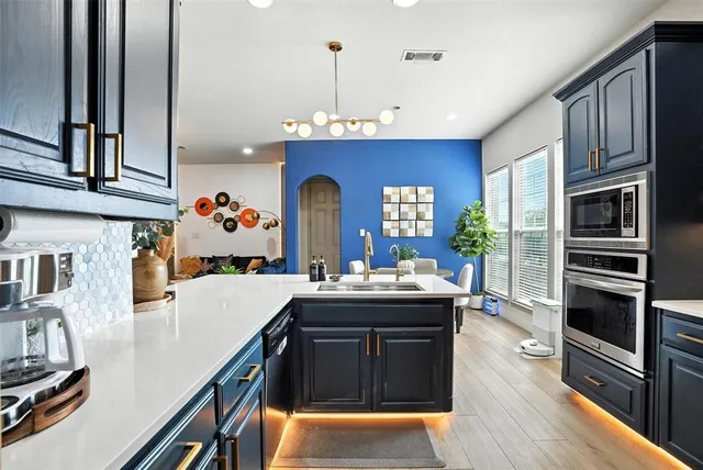 a kitchen with stainless steel appliances granite countertop a stove and a refrigerator