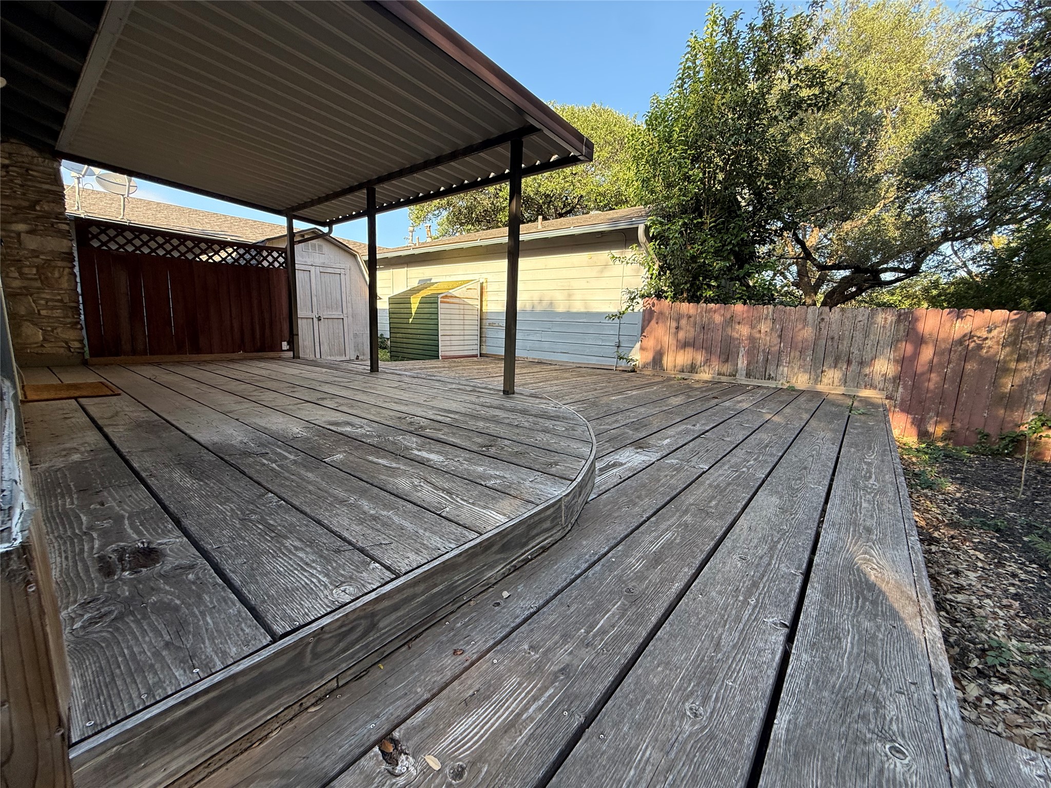 8713 Azalea Trail Austin, TX 78759 - Photo 8 of 13 A spacious wooden deck with a covered patio offers ample outdoor living space.