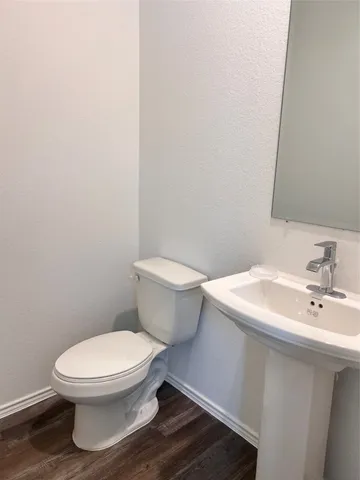 a white toilet sitting next to a bathroom sink