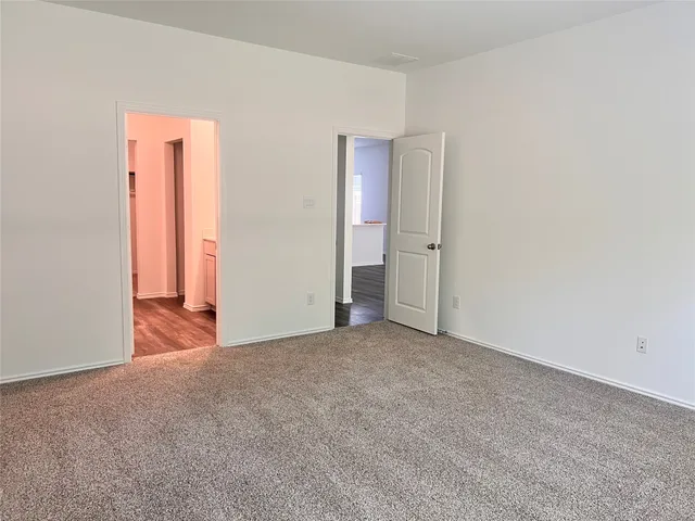 an empty room with closet and mirror