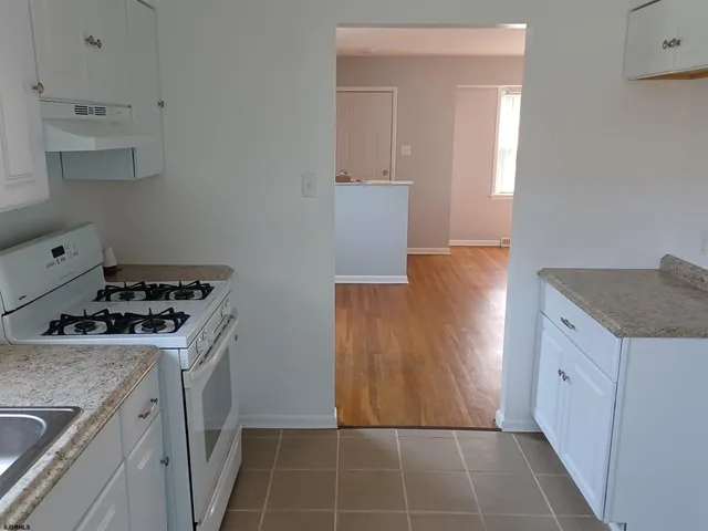 a kitchen with a stove and a refrigerator