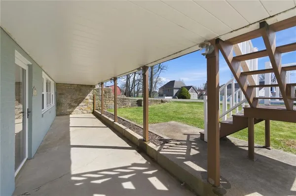 a view of a house with backyard sitting area and garden