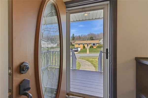 an empty room with wooden floor fireplace and windows