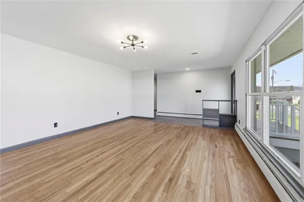 a kitchen with stainless steel appliances granite countertop a stove a sink dishwasher and a refrigerator with wooden floor