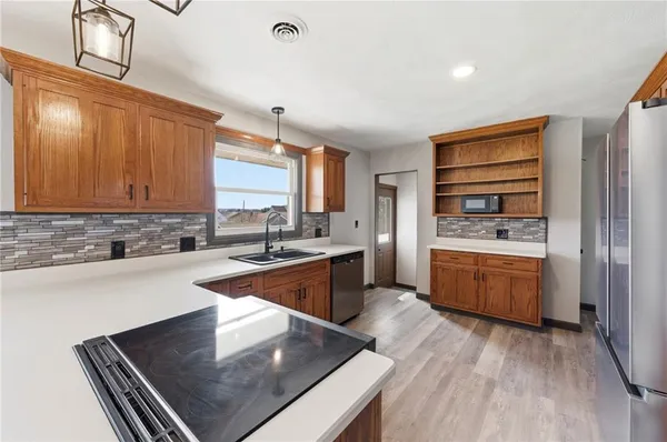 a kitchen with stainless steel appliances a refrigerator and a stove top oven