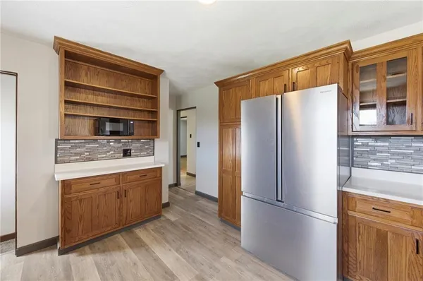 a kitchen with sink a window and cabinets