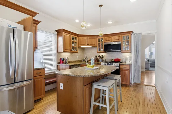 a kitchen with kitchen island a counter top space appliances and cabinets