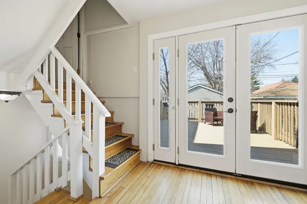 a view of an entryway with wooden floor and door