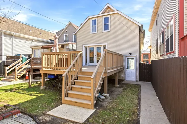 a view of a house with backyard and deck