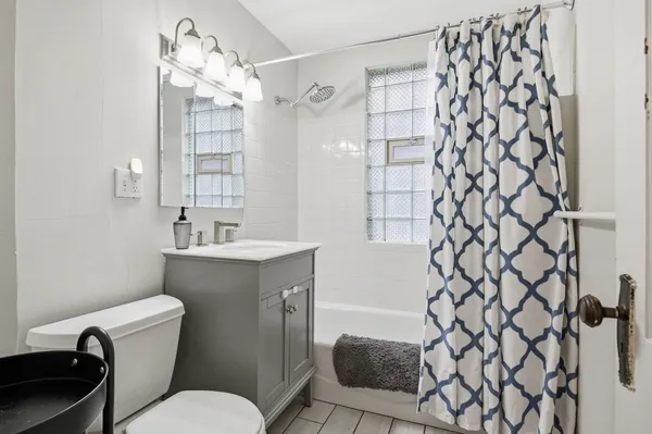 a bathroom with a sink mirror vanity and toilet