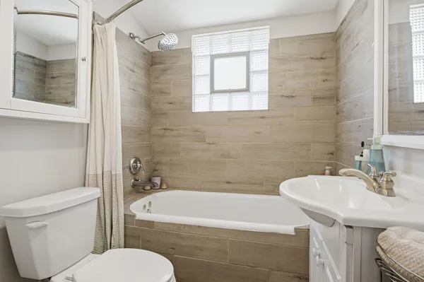 a bathroom with a sink toilet and shower