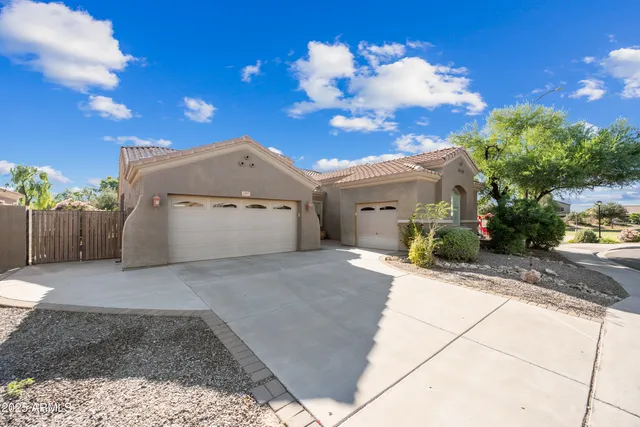 a view of a house with a yard and a garage