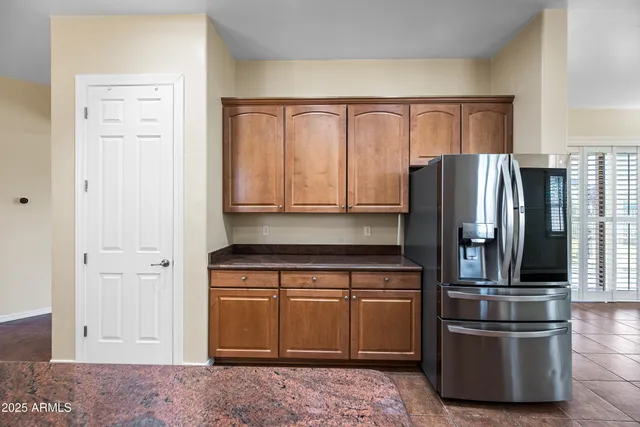 a kitchen with stainless steel appliances granite countertop a refrigerator and a stove