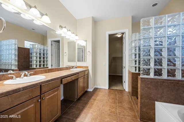 a spacious bathroom with a granite countertop sink and a mirror