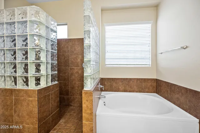 a bathroom with bathtub and window
