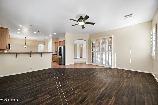 a view of a kitchen with wooden floor and a window