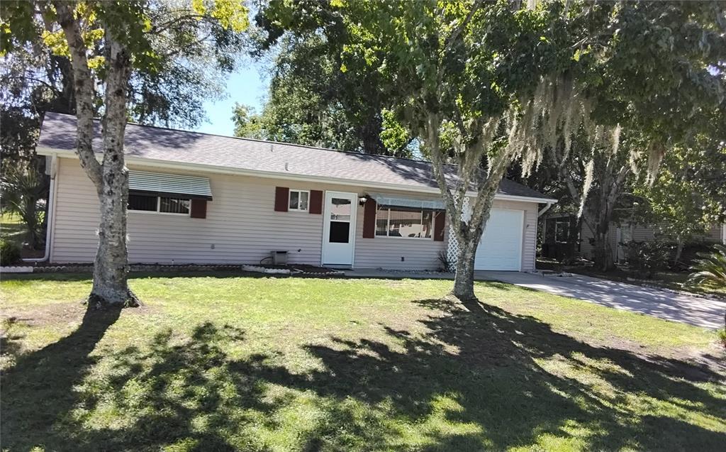 8328 Southwest 106th Place Ocala, FL 34481 - Photo 1 of 23 a view of a house with a yard