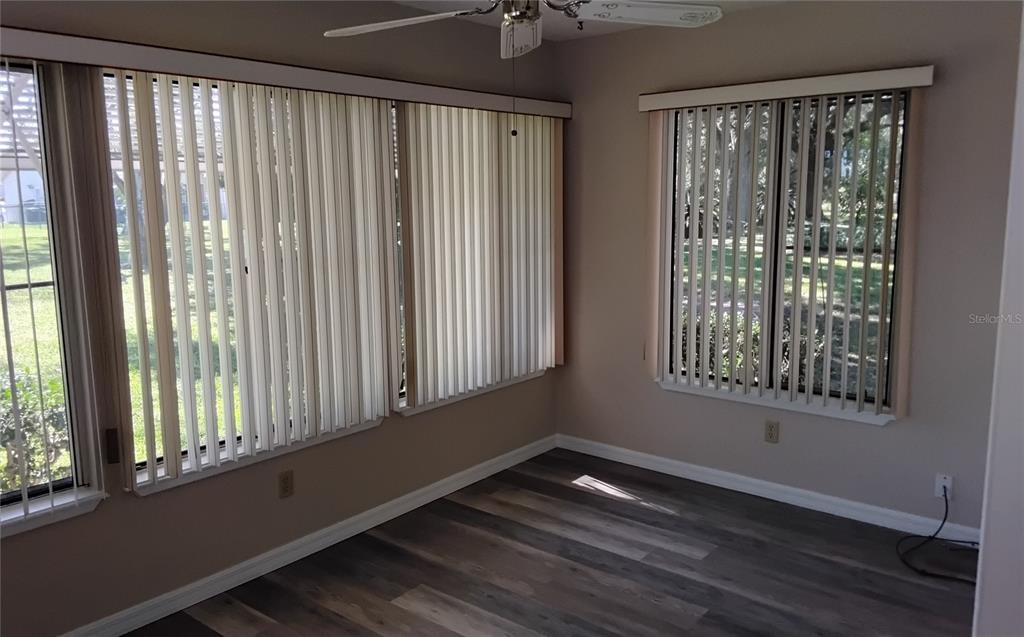 8328 Southwest 106th Place Ocala, FL 34481 - Photo 13 of 23 a view of an empty room with wooden floor and a window