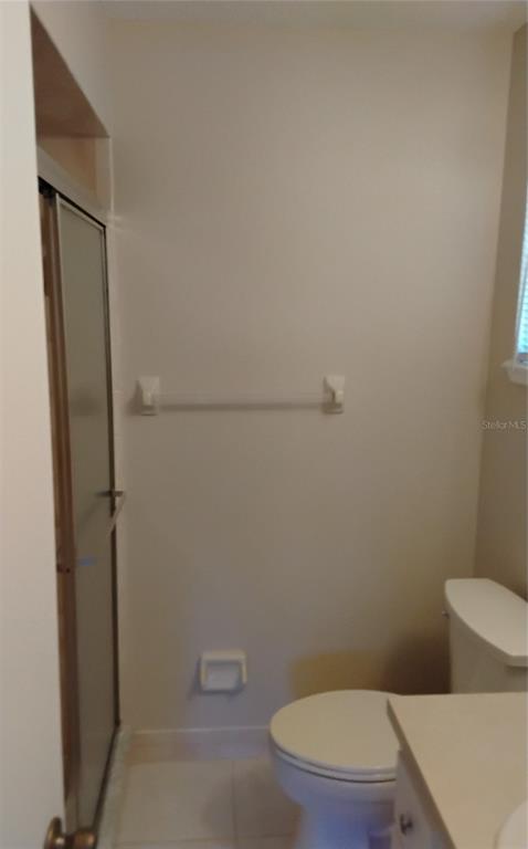 8328 Southwest 106th Place Ocala, FL 34481 - Photo 19 of 23 a white toilet sitting next to a shower