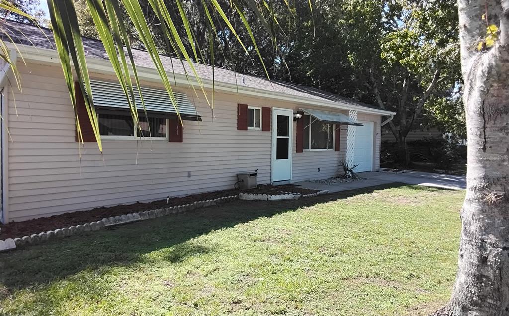 8328 Southwest 106th Place Ocala, FL 34481 - Photo 2 of 23 a front view of a house with garden
