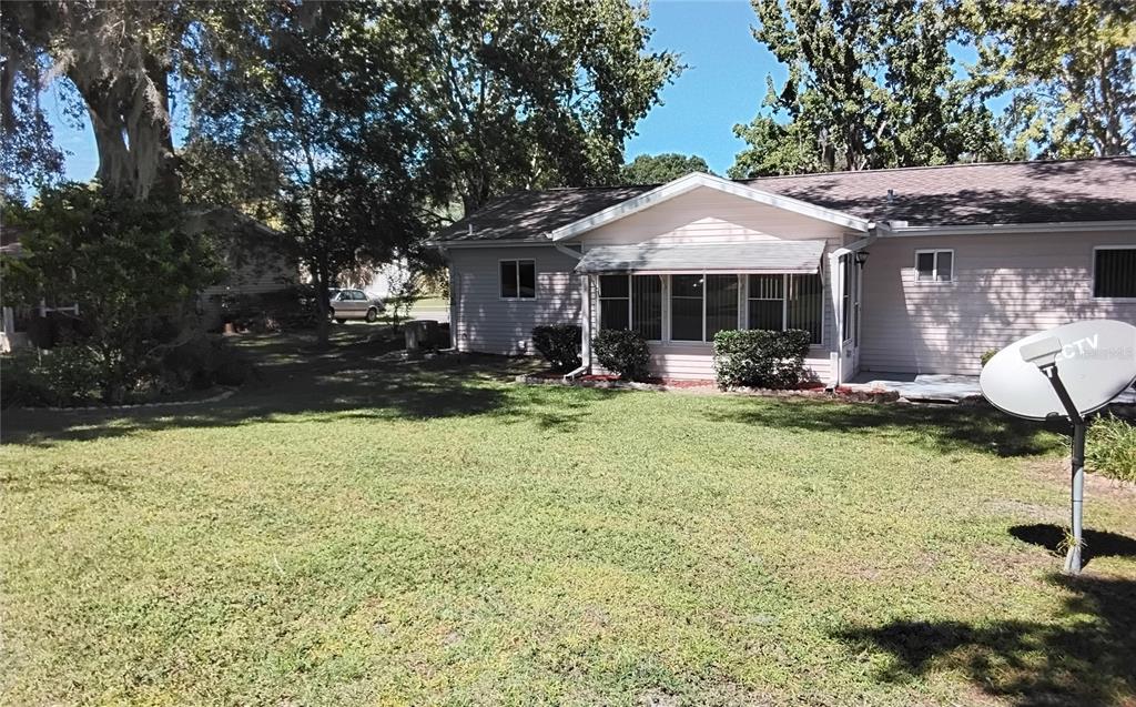 8328 Southwest 106th Place Ocala, FL 34481 - Photo 5 of 23 a backyard of a house with yard and outdoor seating