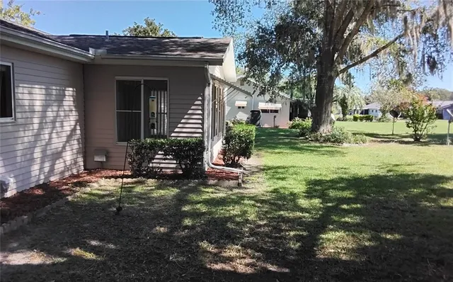 a view of a house with yard and sitting area