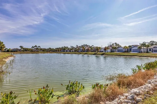 a view of a lake with houses in the background