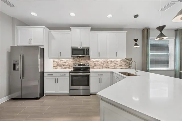 a kitchen with a refrigerator sink and stove