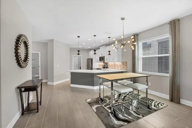 a room with lots of wooden furniture and a chandelier