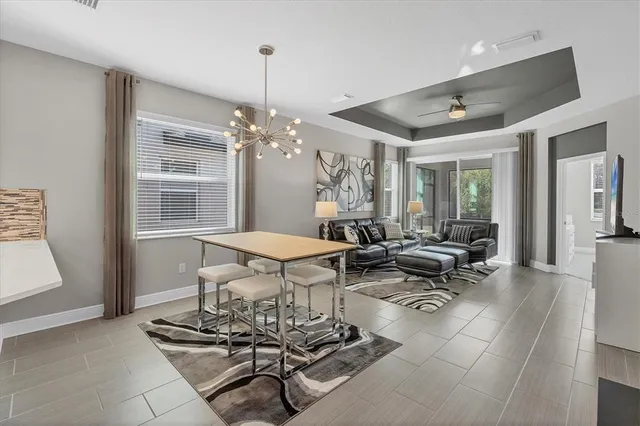 a living room with furniture a chandelier and a table