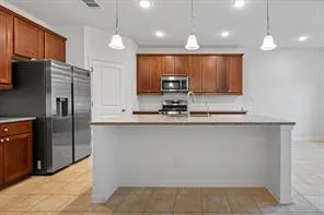 a kitchen with stainless steel appliances a refrigerator and a sink