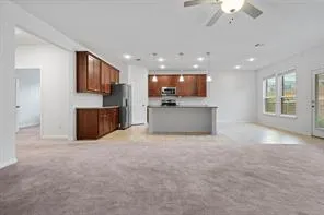 a kitchen with stainless steel appliances granite countertop a sink stove and microwave