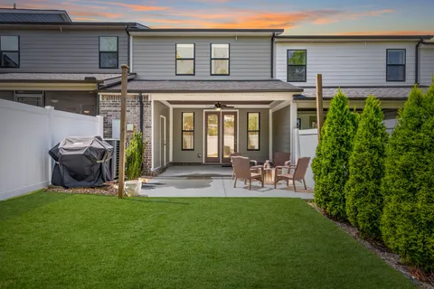 a front view of a house with garden and patio