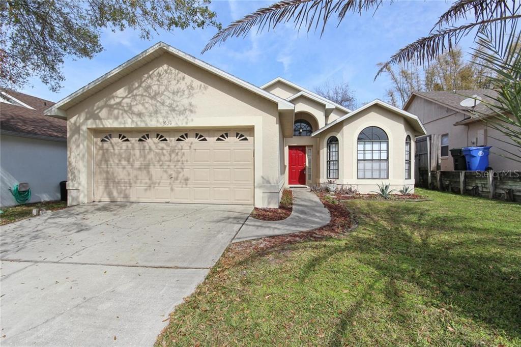 1630 Riveredge Road Oviedo, FL 32766 - Photo 1 of 1 a front view of a house with a yard and garage