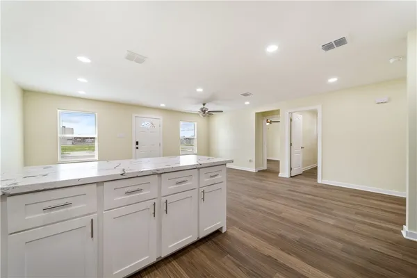 a spacious bathroom with a granite countertop sink and a mirror