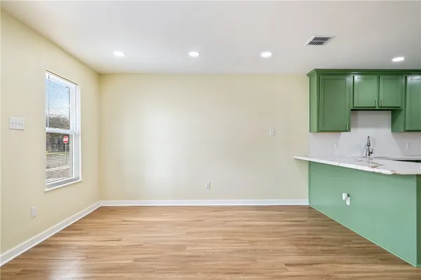 a view of a kitchen with a sink and a window