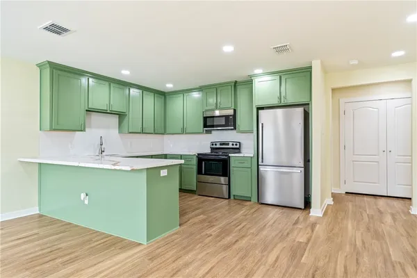 a kitchen with a refrigerator and a sink