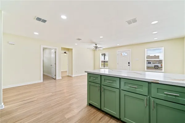 a view of kitchen with stainless steel appliances cabinets and wooden floor