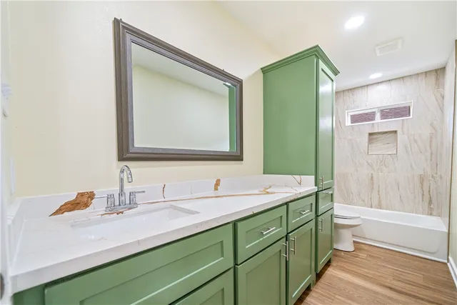 a bathroom with a double vanity sink mirror and toilet