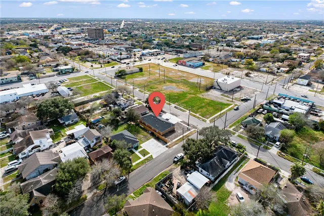 an aerial view of residential houses with outdoor space