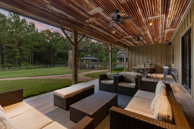 a view of a patio with couches and a big yard