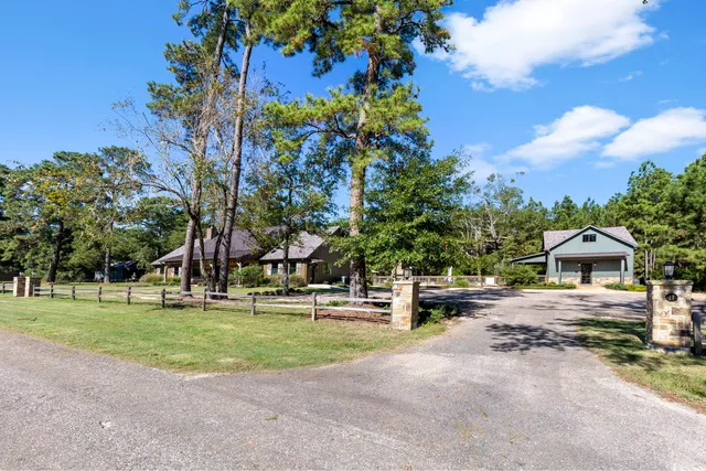 a view of a house with a yard and tree s